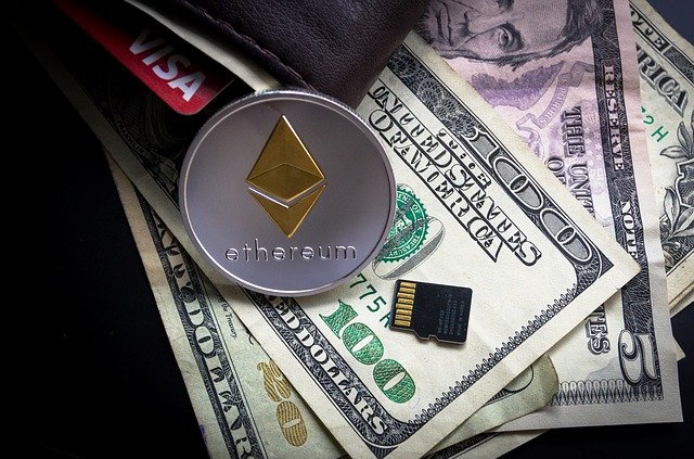 zdjęcie prezentujące monetę z logo Ethereum na tle dolarów amerykańskich